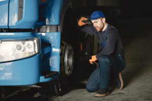 Young worker checks wheel truck